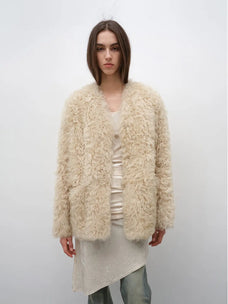 Model wearing the Castle Dusk natural ivory V-neck Toscana shearling coat, front view