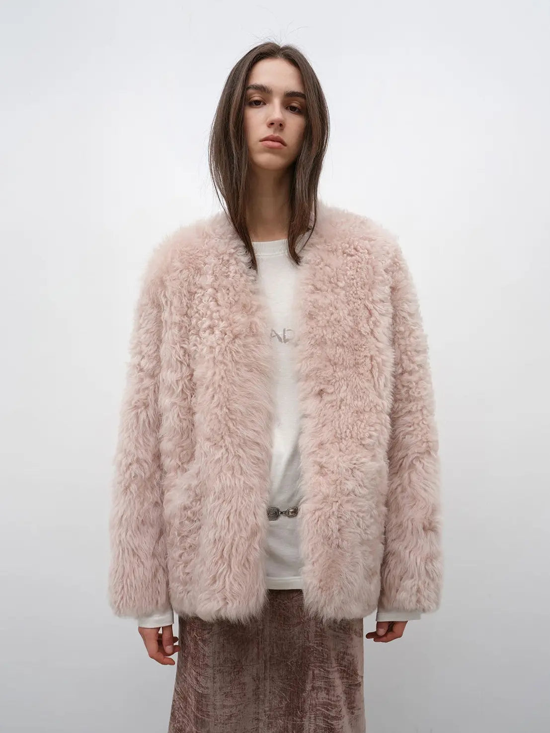 Model wearing the Castle Dusk pink V-neck Toscana shearling coat, front view