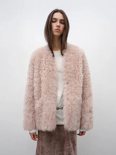 Model wearing the Castle Dusk pink V-neck Toscana shearling coat, front view