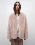 Model wearing the Castle Dusk pink V-neck Toscana shearling coat, front view