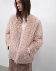 Model styling the Castle Dusk pink V-neck Toscana shearling coat, close lifestyle view