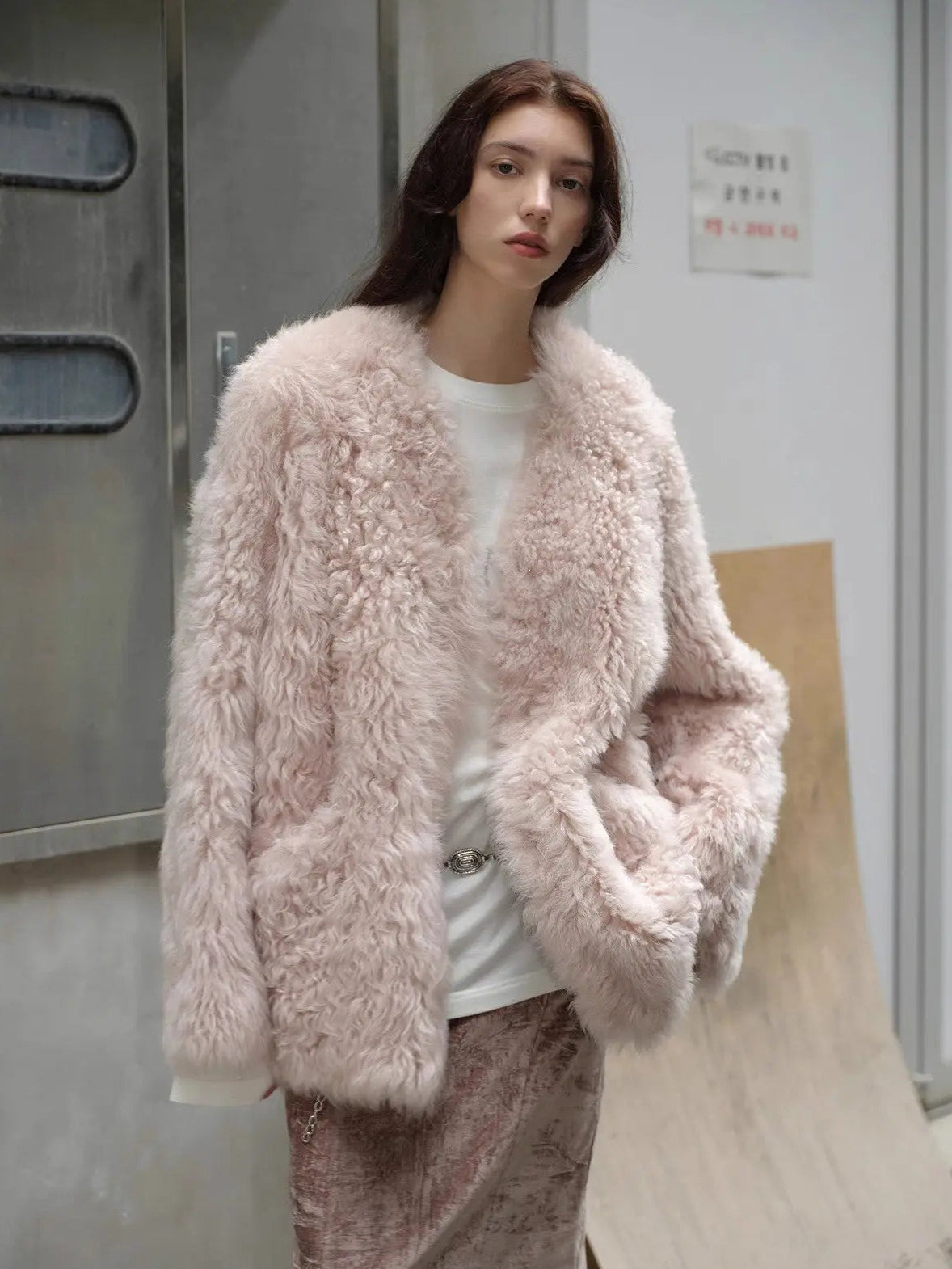 Model styling the Castle Dusk pink V-neck Toscana shearling coat outdoors