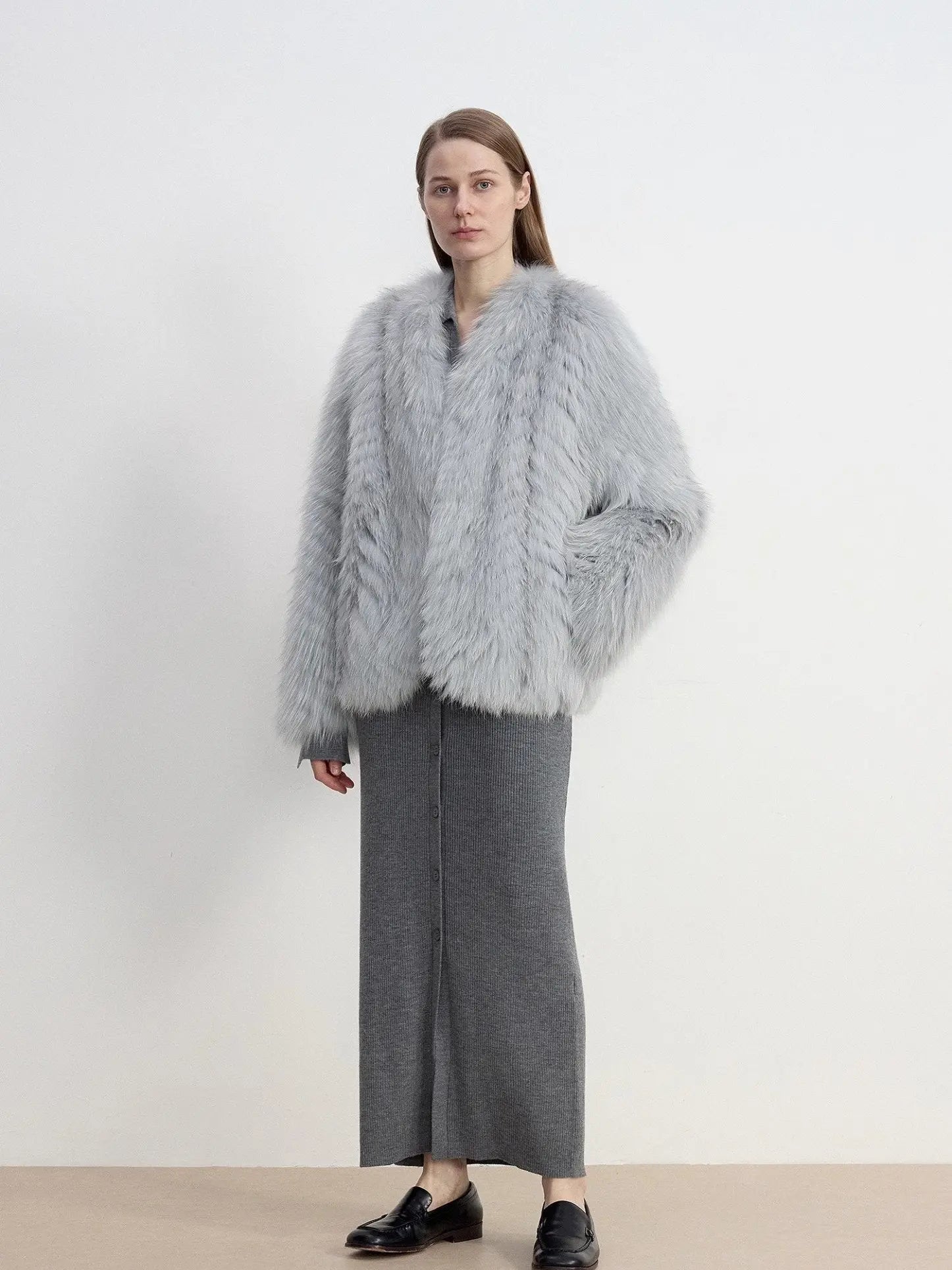 Model styling Champagne Ice Blue fox fur coat with hand in pocket