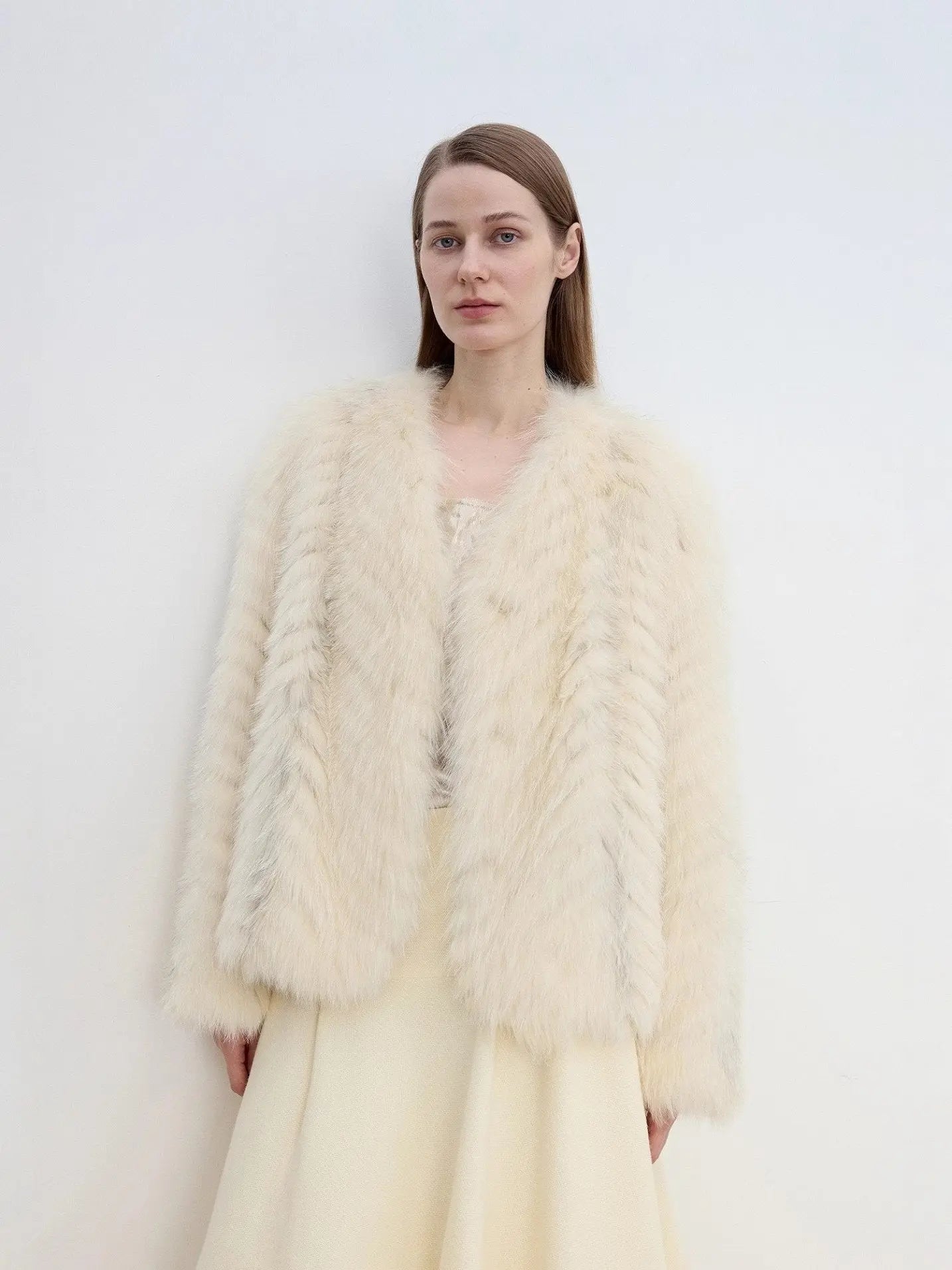 Model wearing Champagne Light Yellow fox fur jacket with hand in pocket