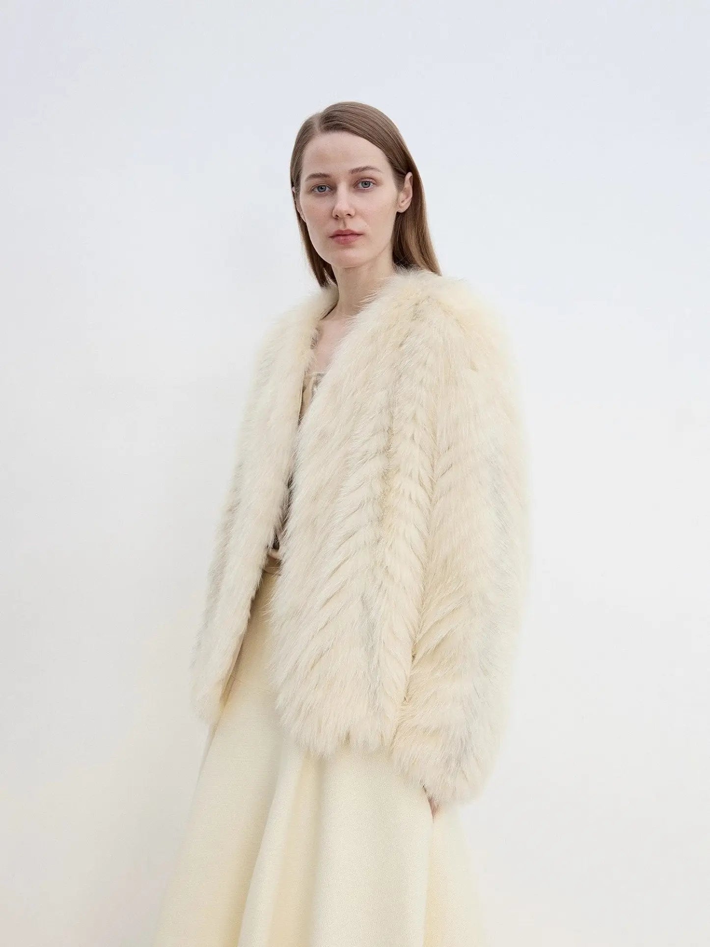 Model styling Champagne Light Yellow fox fur coat, three-quarter view
