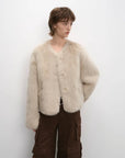 Woman wearing the Darcy Manor wheat Toscana shearling coat, front view