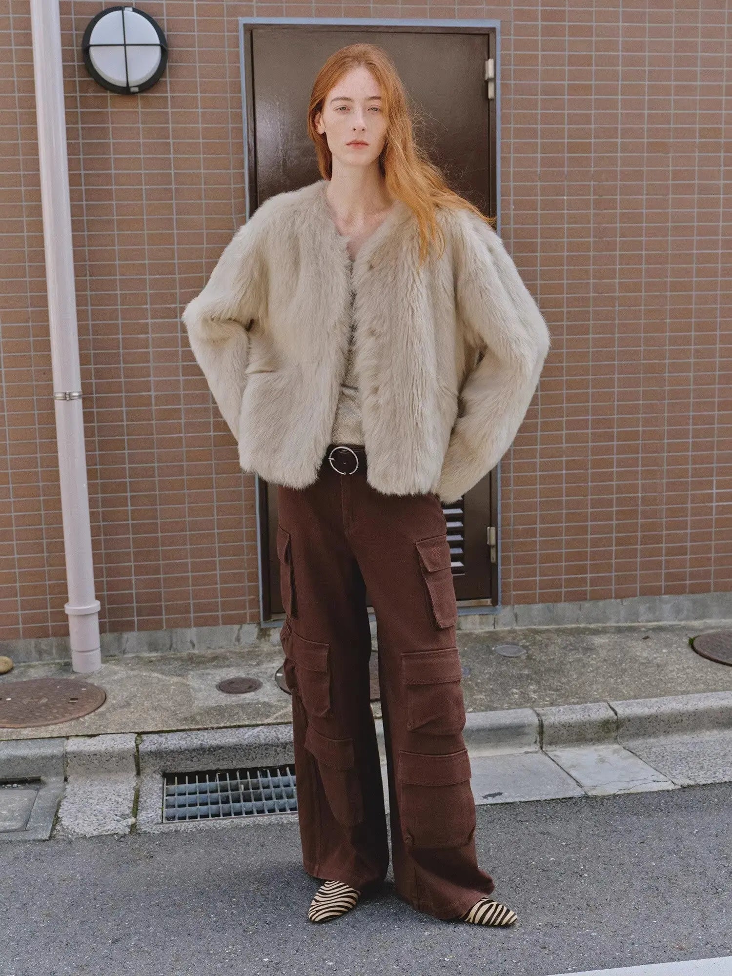 Woman styling the Darcy Manor wheat Toscana shearling coat outdoors
