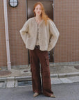 Woman styling the Darcy Manor wheat Toscana shearling coat outdoors