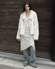 Woman styling the Dream Walk milky white Toscana shearling coat outdoors
