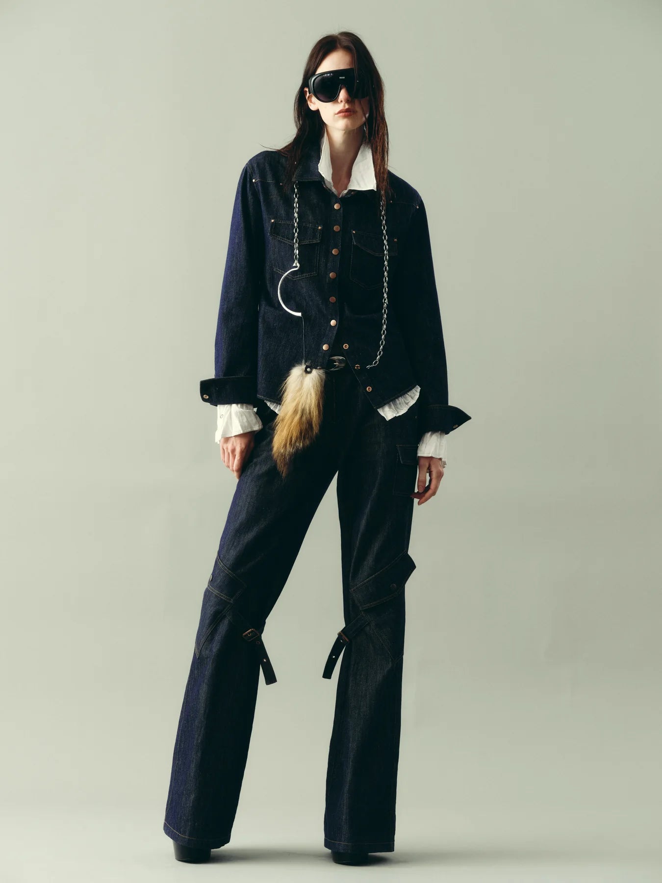 Black outerwear styled as a clean city column with sharp trousers