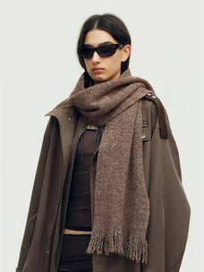 Woman wearing a brown Firelady Fur shimmer Merino wool and cashmere fringe scarf