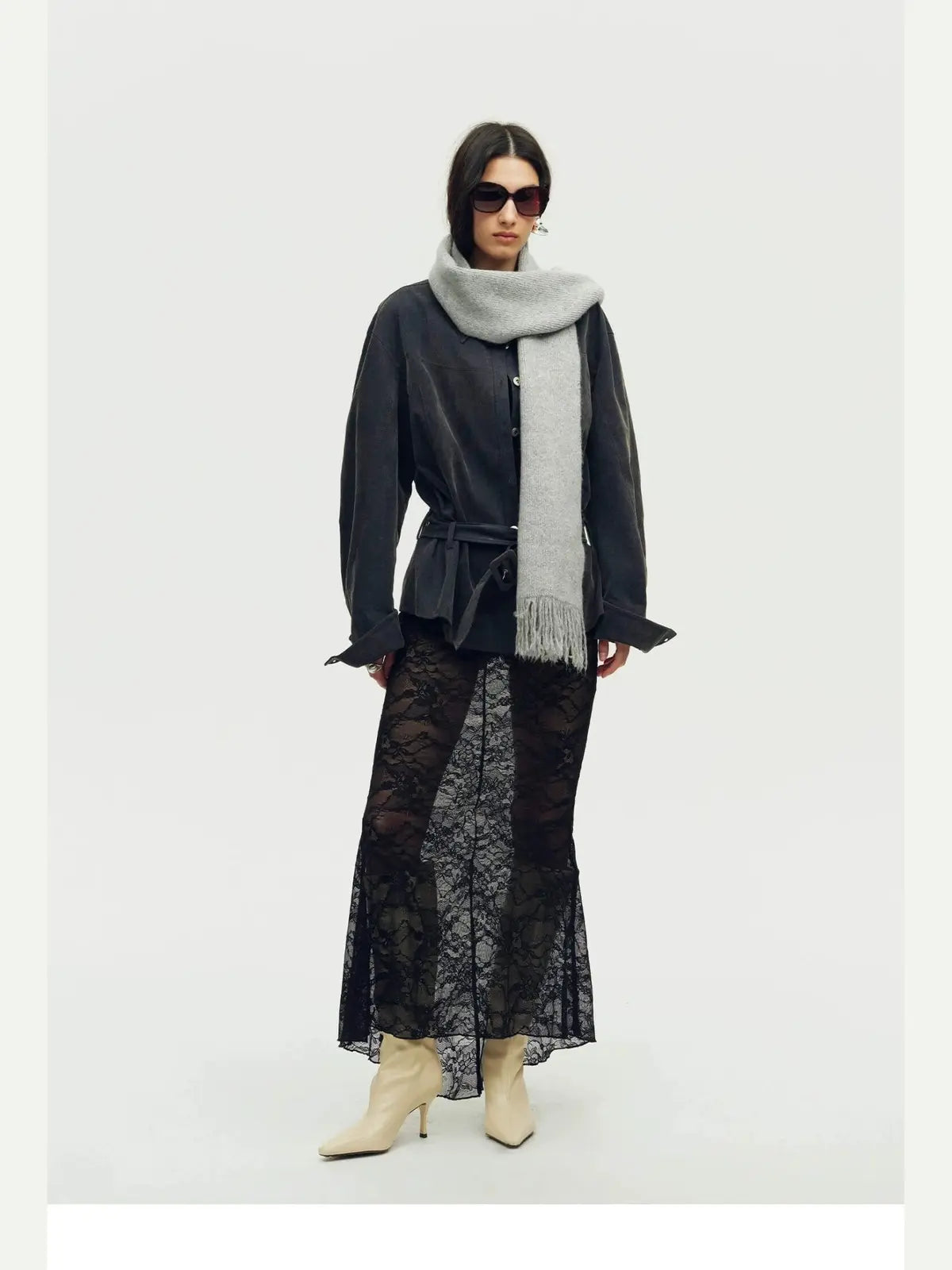 Woman wearing a grey Firelady Fur shimmer Merino wool and cashmere fringe scarf