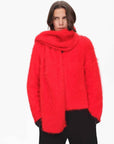 Woman wearing a red alpaca wool scarf in a front styling view