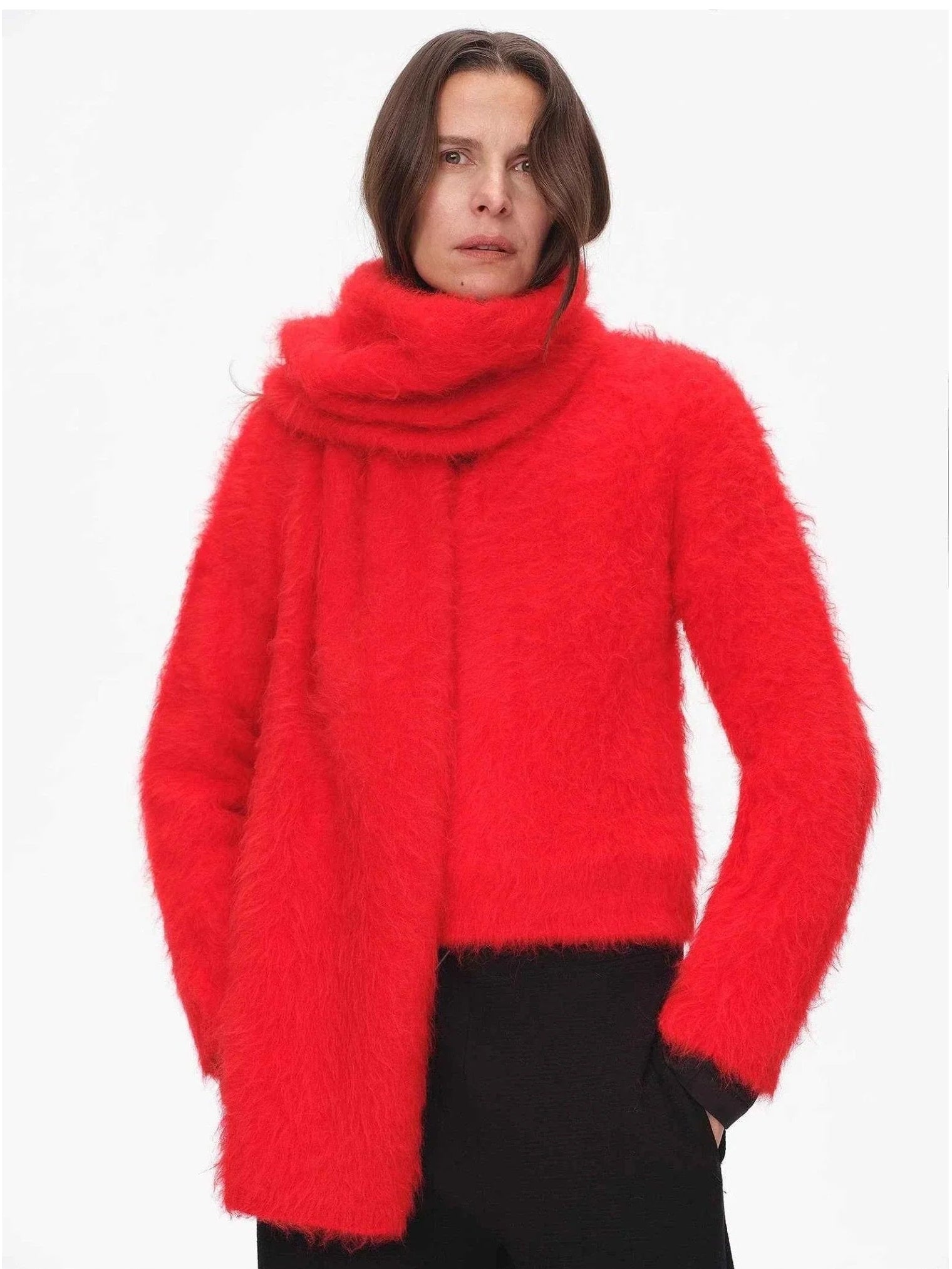 Woman styling a red alpaca wool scarf with a matching sweater