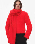 Woman styling a red alpaca wool scarf with a matching sweater