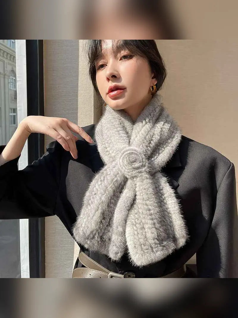 Woman wearing a silver gray mink flower scarf with tailored outfit