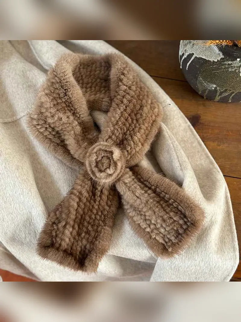 Woman styling a silver gray mink flower scarf by a window