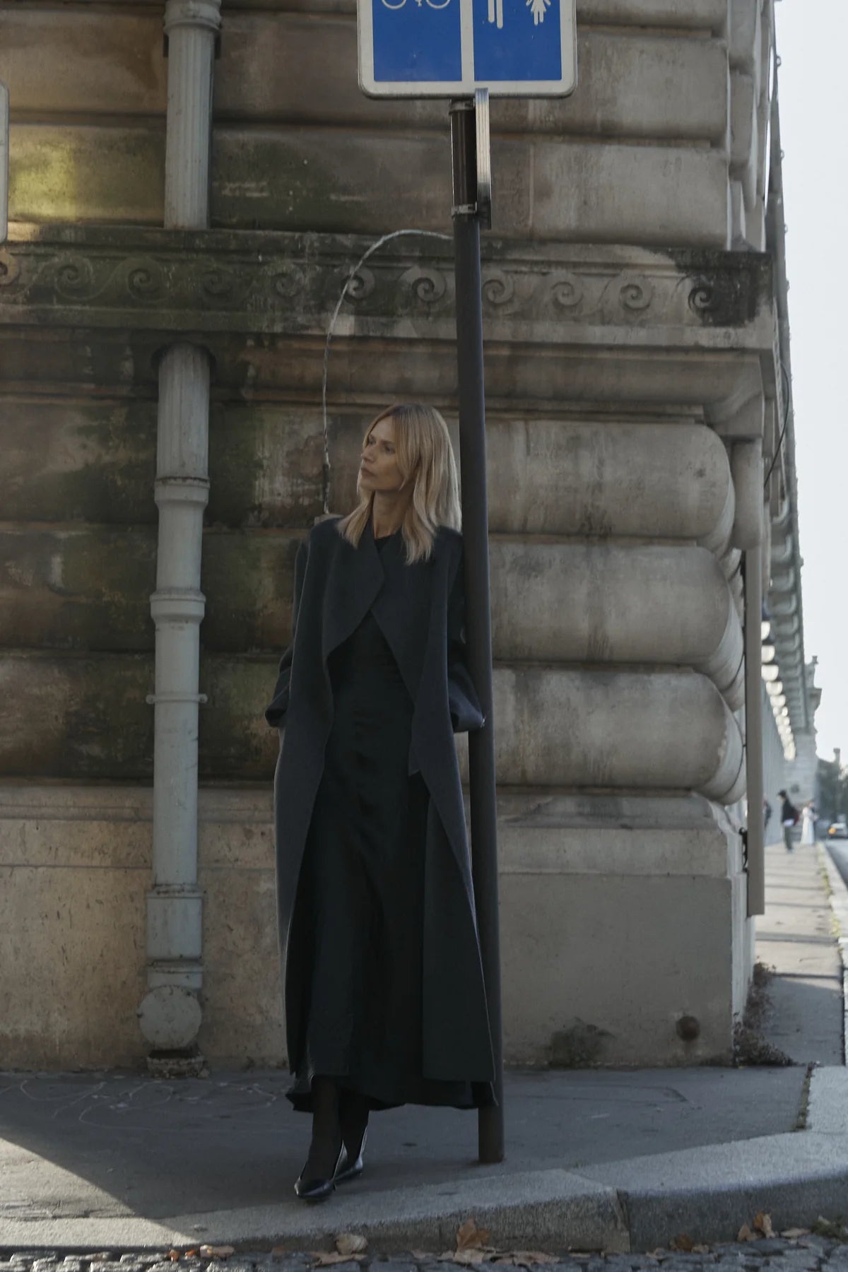 Black long coat over a light vertical base for contrast control