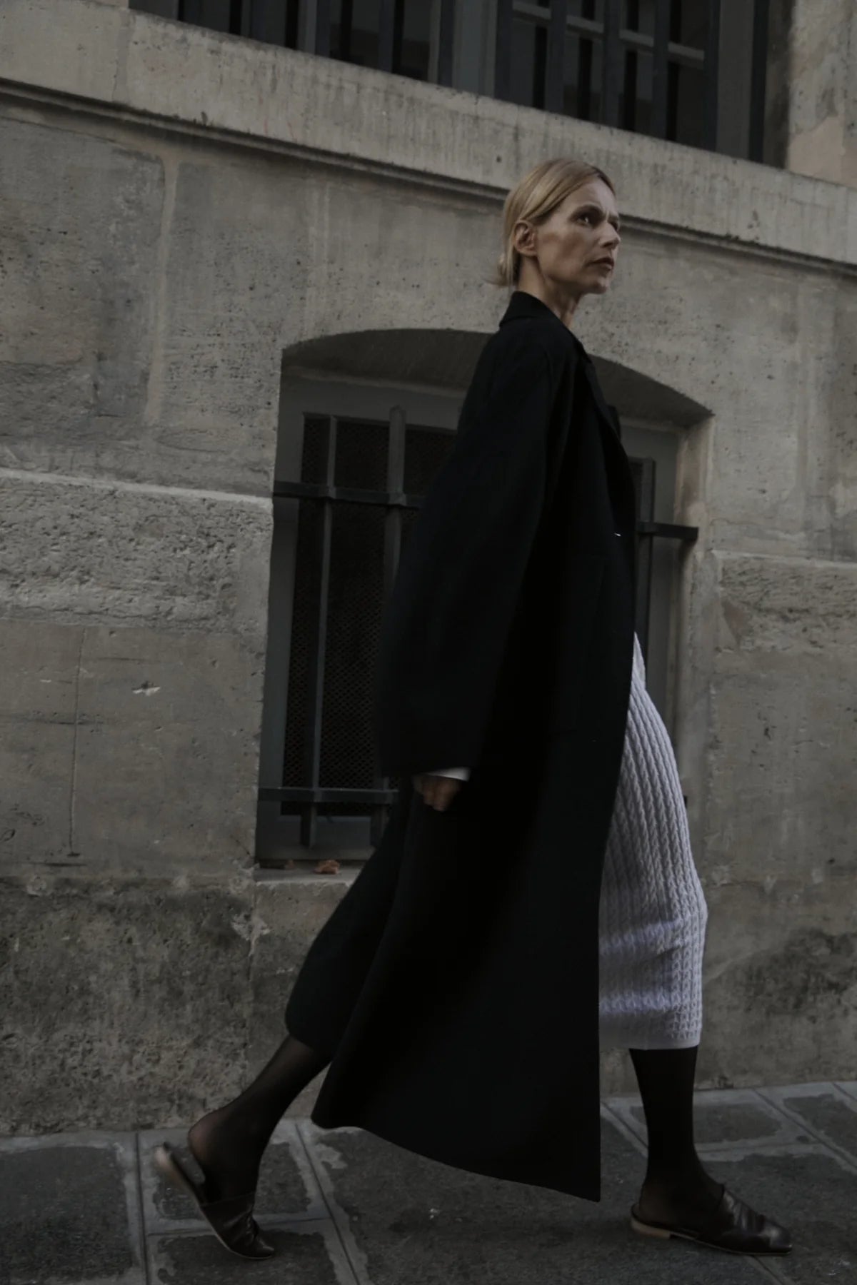 Black long coat walking reference for relaxed long-line styling