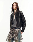 Black oil-waxed goatskin cropped leather moto jacket on model