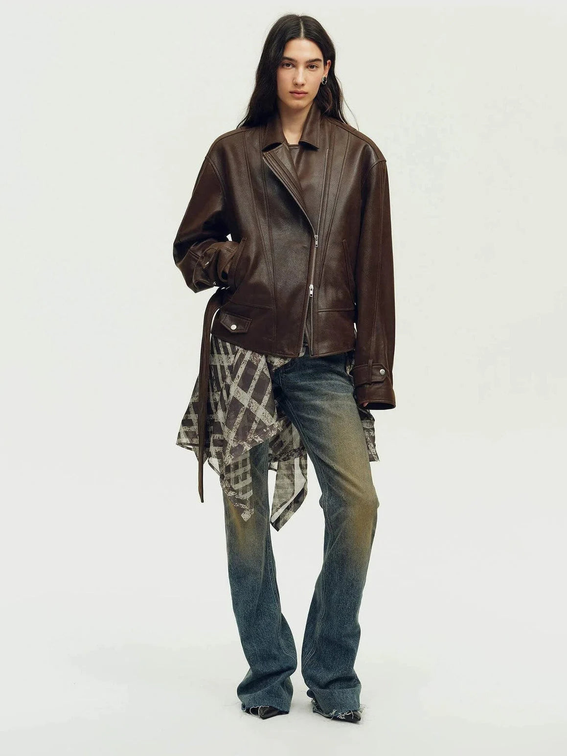 Woman wearing a brown leather jacket in a full-length view for comparing silhouette, fit, and styling