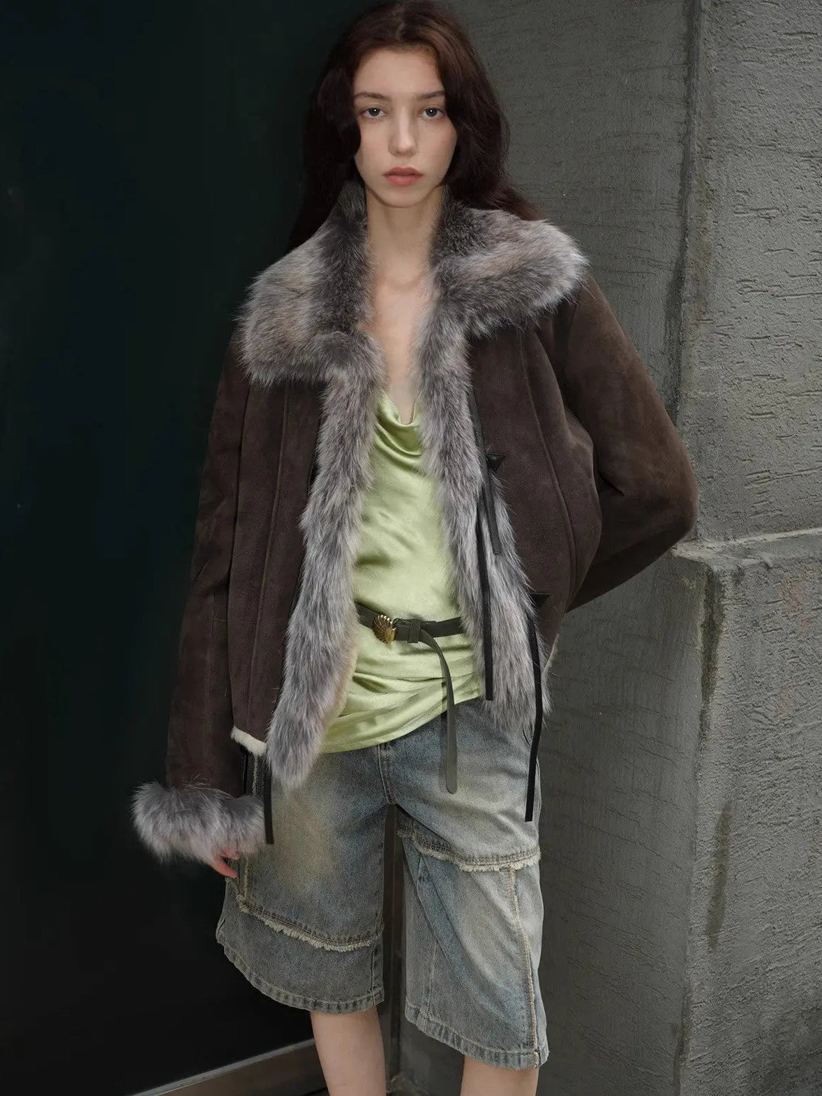 Woman styling the Florence dark brown shearling coat outdoors, close view