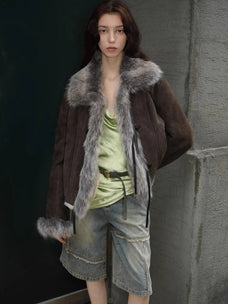Woman styling the Florence dark brown shearling coat outdoors, close view