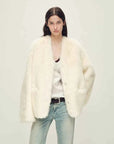 Woman wearing the Freezing Point Rum classic white Toscana shearling coat