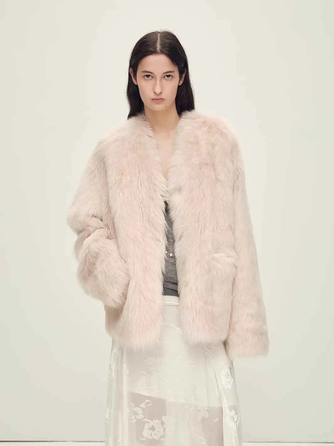 Woman wearing the Freezing Point Rum dirty pink Toscana shearling V-neck coat