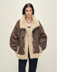 Model wearing the Galaxy Gala fog brown Merino shearling coat, front view