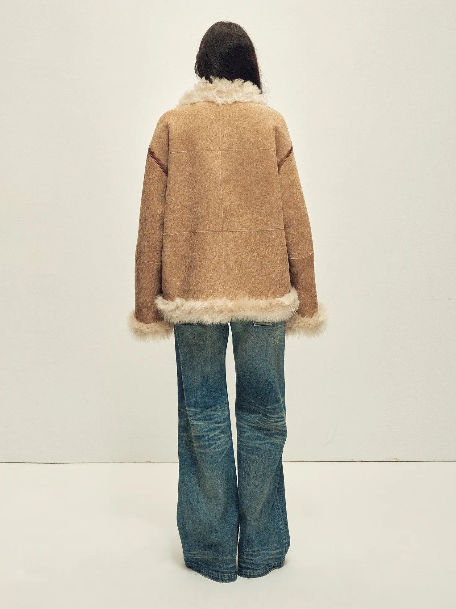 Model wearing the Galaxy Gala tortoiseshell yellow Merino shearling coat, back view