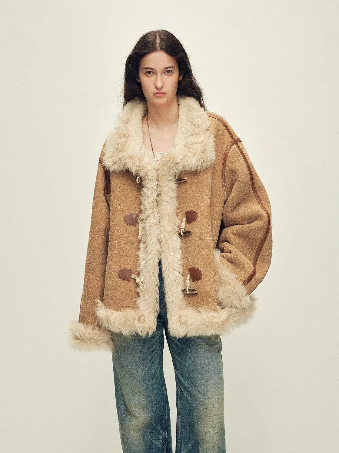 Model wearing the Galaxy Gala tortoiseshell yellow Merino shearling coat, front view