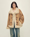 Model wearing the Galaxy Gala tortoiseshell yellow Merino shearling coat, front view