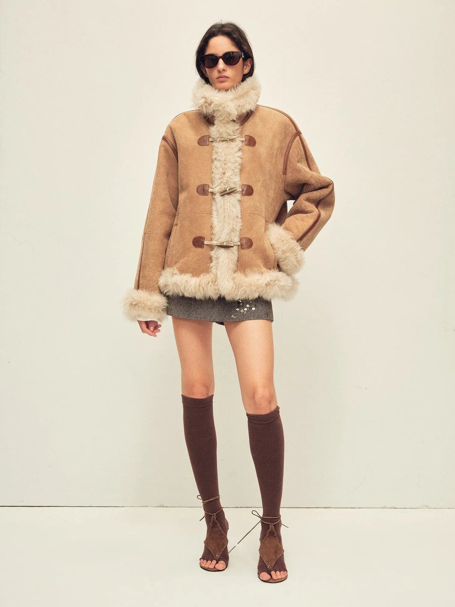 Model wearing the Galaxy Gala tortoiseshell yellow Merino shearling coat, full-length view