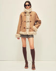 Model wearing the Galaxy Gala tortoiseshell yellow Merino shearling coat, full-length view