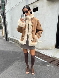 Model styling the Galaxy Gala tortoiseshell yellow Merino shearling coat outdoors, front view