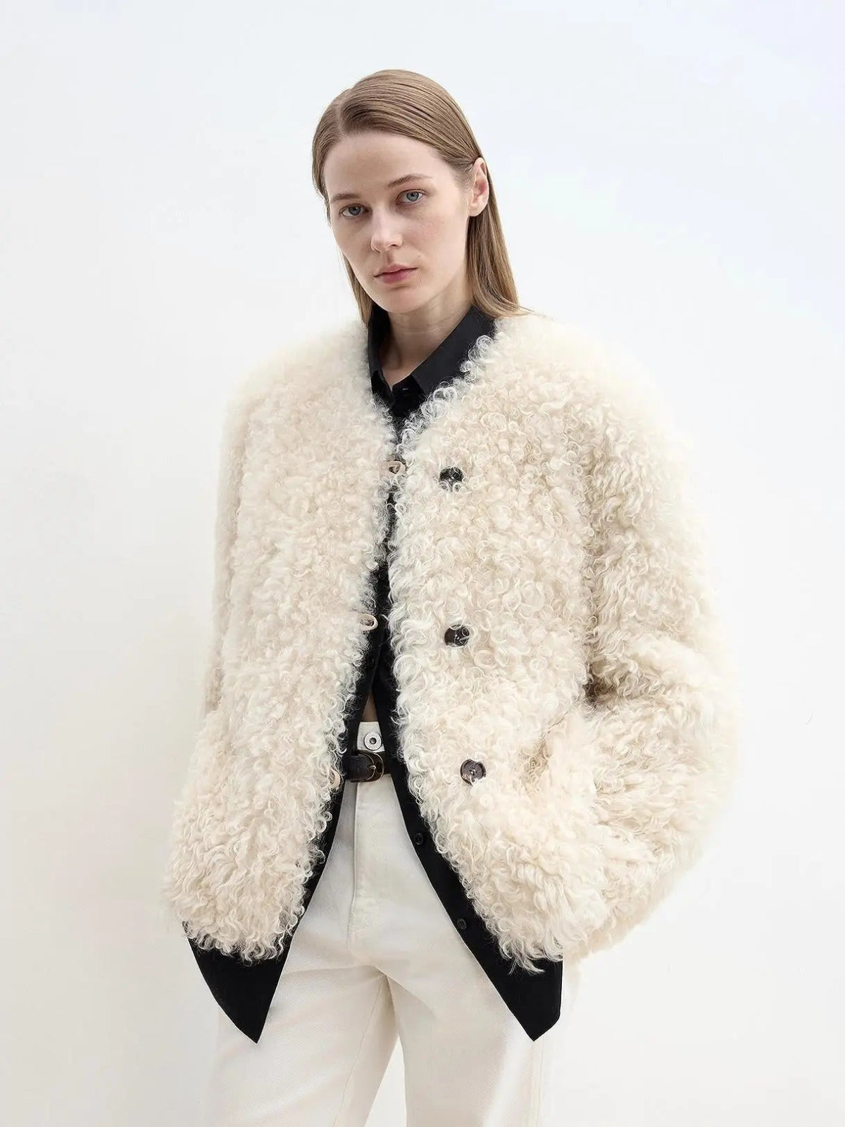 Woman wearing the Ghost Horse Girl off-white Merino curly shearling coat, close front view