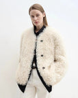 Woman wearing the Ghost Horse Girl off-white Merino curly shearling coat, close front view