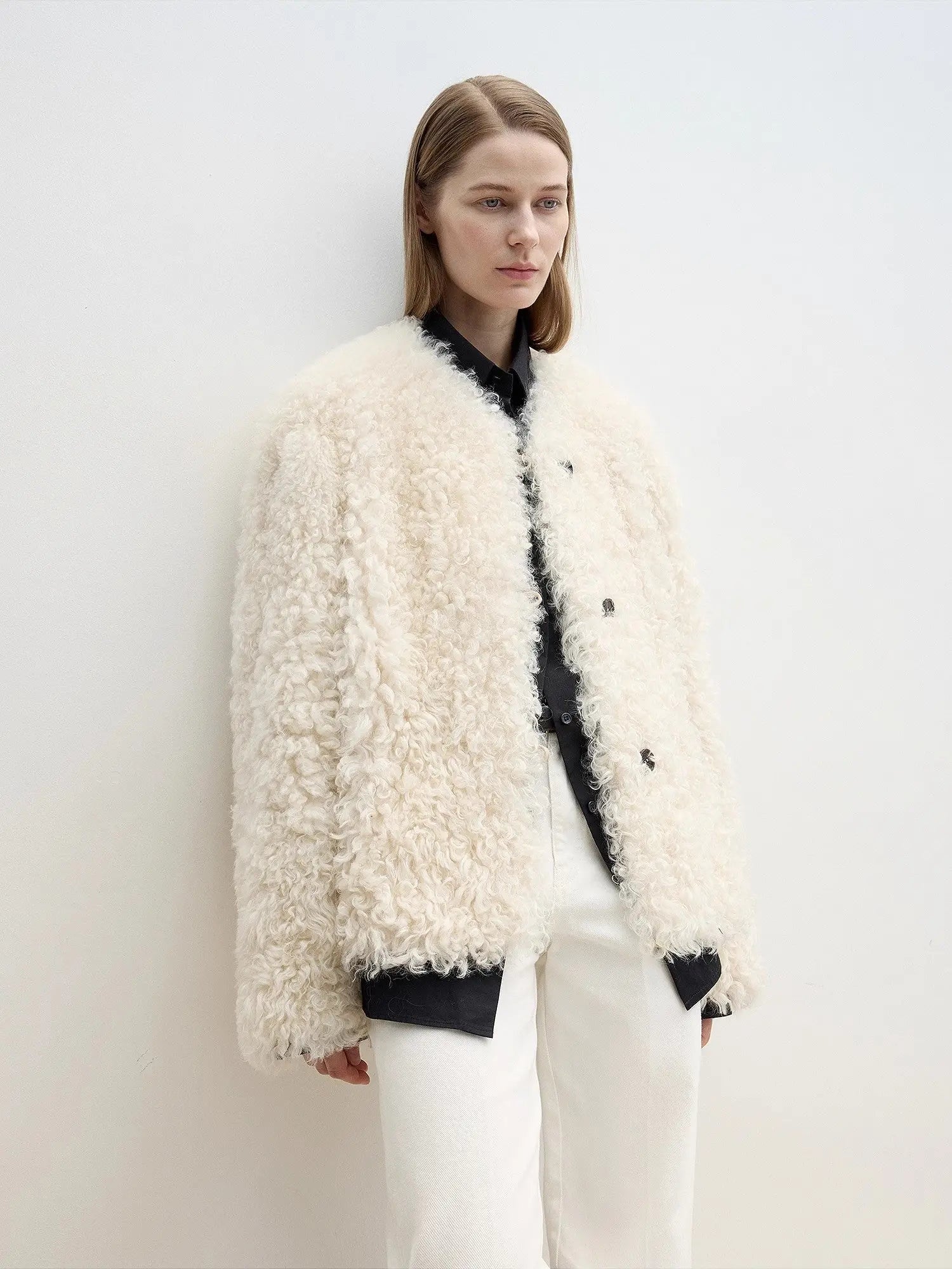 Off-white Merino curly shearling coat, angled three-quarter view