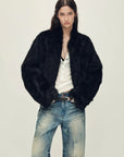 Woman wearing the Healing Eros black Toscana shearling coat, front view