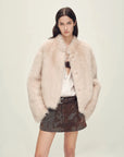 Woman wearing the Healing Eros dirty pink Toscana shearling coat, front view