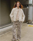 Woman styling the Healing Eros white Toscana shearling coat outdoors