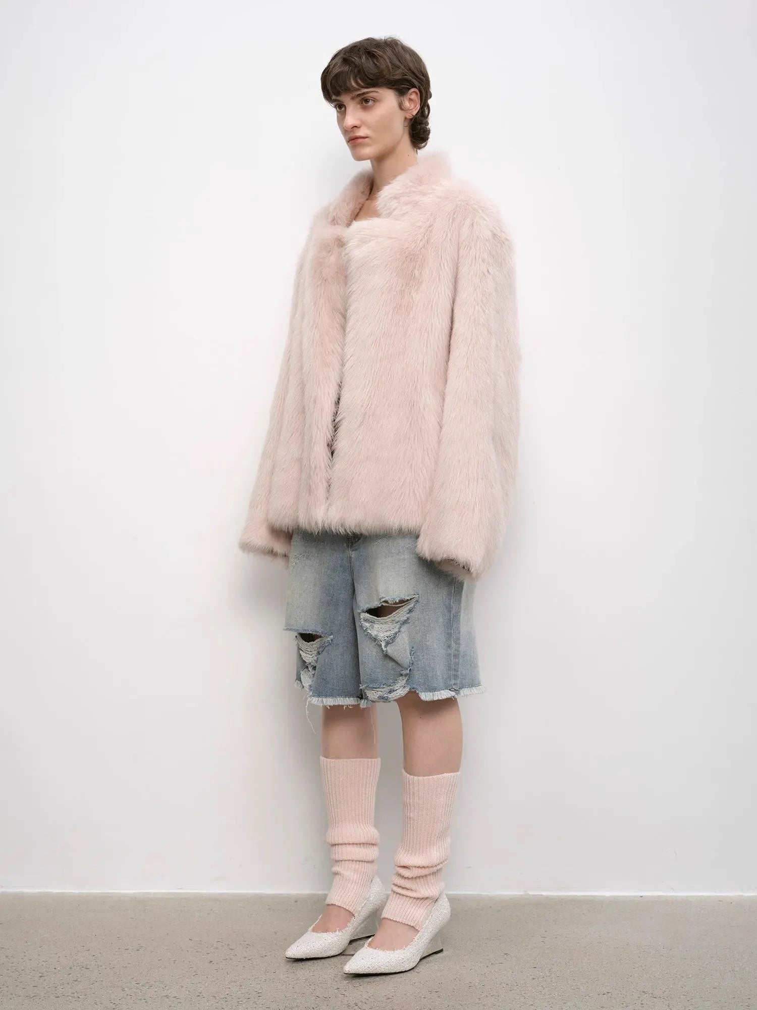 Woman styling the Heartbeat Mark dirty pink shearling coat, full-length view