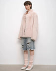 Woman styling the Heartbeat Mark dirty pink shearling coat, full-length view