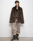Woman styling the Heartbeat Mark dark brown Toscana coat, full-length view