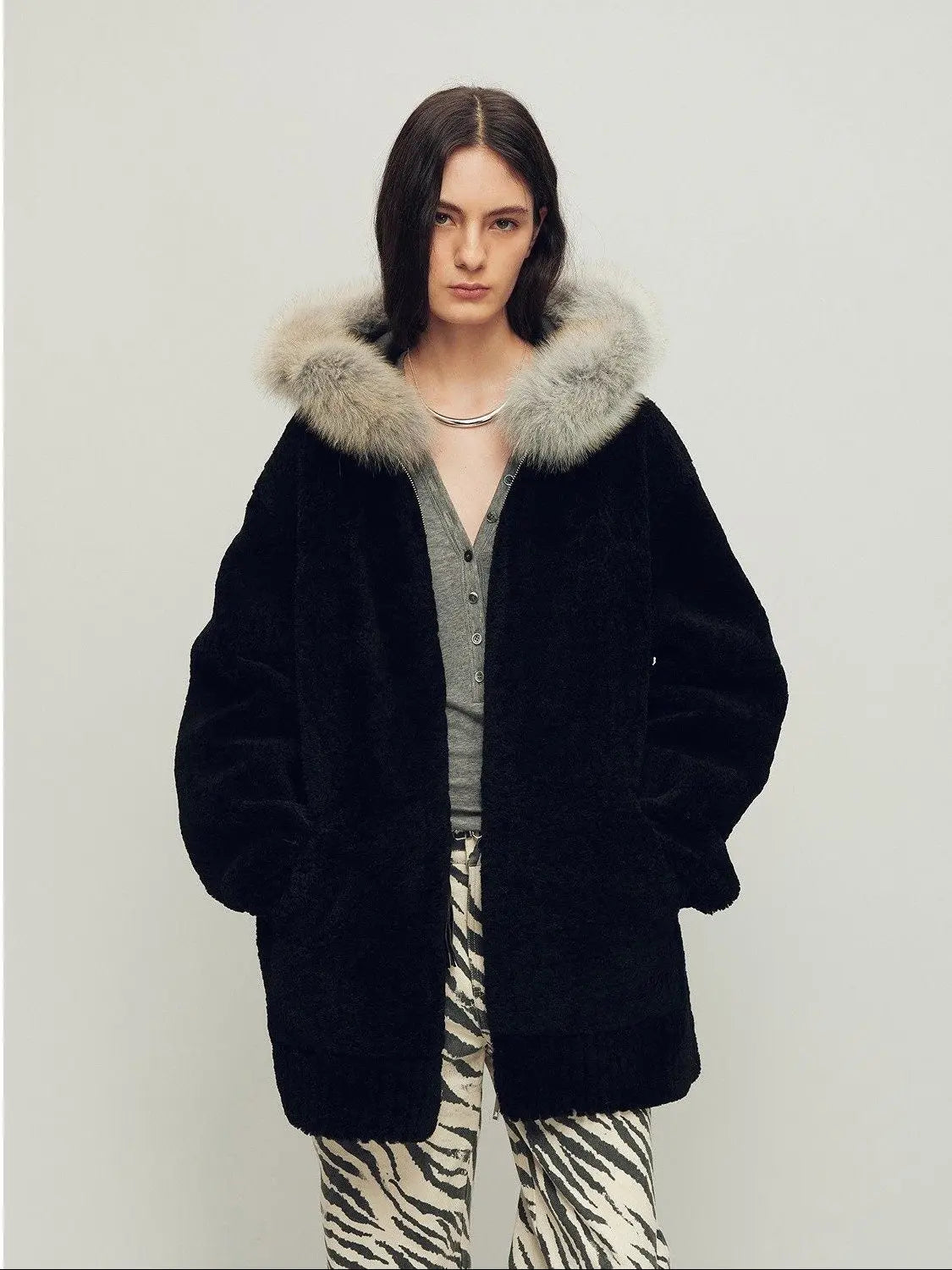 Model wearing Hokkaido Melody black long hooded Merino shearling coat