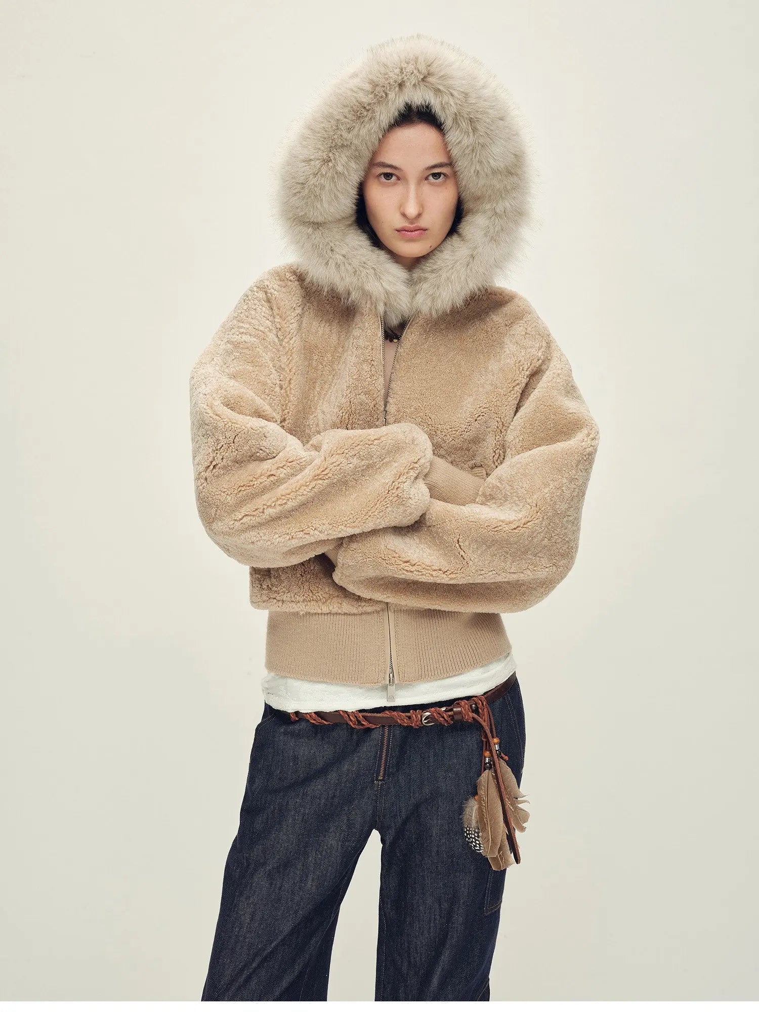 Model wearing Hokkaido Melody camel short hooded Merino shearling jacket with hood up