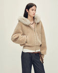 Model wearing Hokkaido Melody camel short hooded Merino shearling jacket