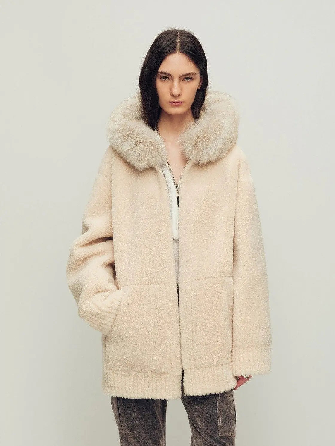 Model wearing Hokkaido Melody off-white long hooded Merino shearling coat
