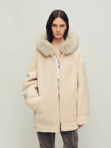 Model wearing Hokkaido Melody off-white long hooded Merino shearling coat